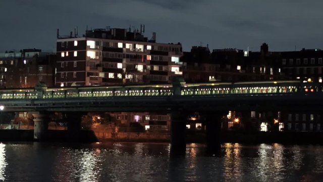 London Tube crossing the River Thames by night. London