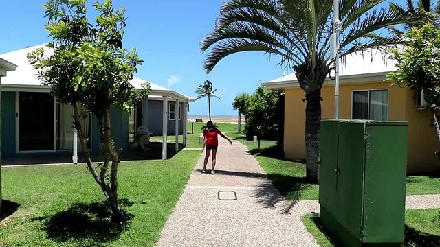Young Girl walking funny in a tropical setting