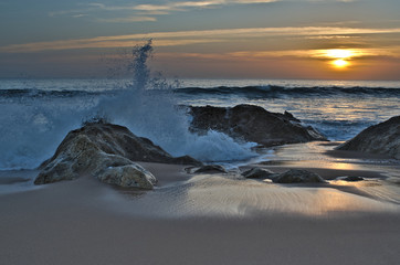 Obraz na płótnie Canvas Waves and sunset in Salgados beach. Albufeira, Portugal