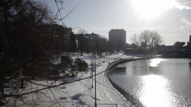 A panning shot of Tammerkoski at sunset with hotel Ilves in the background