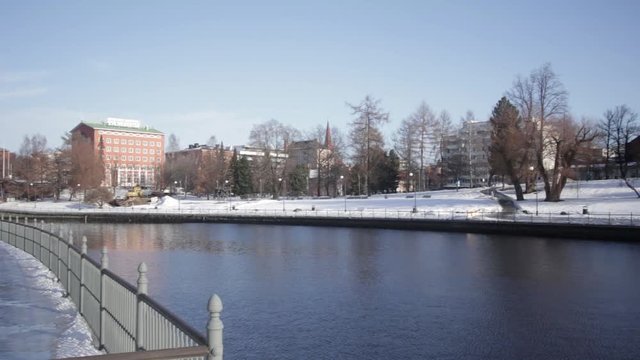 A panning shot of Tammerkoski at sunset with hotel Ilves in the background