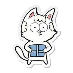 sticker of a happy cartoon cat with present