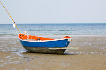 Image of small boat sitting on the beach.