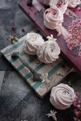 Traditional Russian homemade merengue marshmallow or zephyr on a vintage tray on wooden background. Copy space