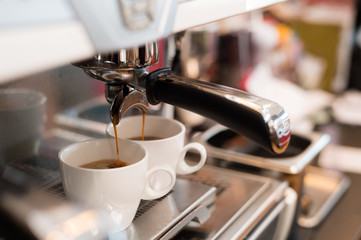 hot coffee in white cup on coffee maker