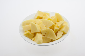 Chopped potato pieces, white plate