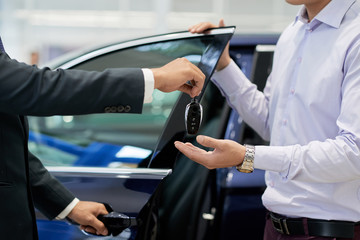 Salesman giving car keys