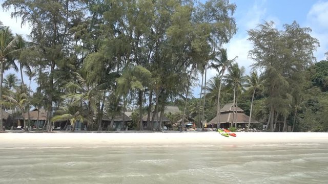 Resort on the beach with surrounded by green trees palm trees and coconut trees. A leisure spot. Tourism travel concept.