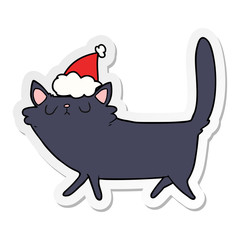 sticker cartoon of a black cat wearing santa hat