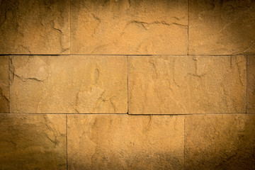Old yellow stone wall background