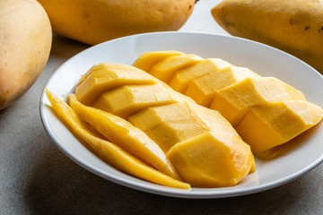 Ripe Barracuda Mango in white plate