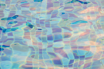 Blue pool water with sun reflections