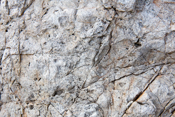 Rock texture and surface background. Cracked and weathered natural stone background.