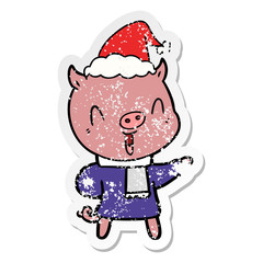 happy distressed sticker cartoon of a pig in winter clothes wearing santa hat