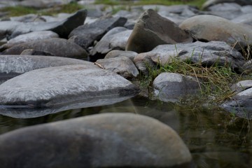 Fototapeta na wymiar Rocks in a Still Stream