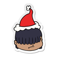 sticker cartoon of a face with hair over eyes wearing santa hat