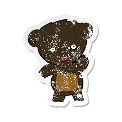 retro distressed sticker of a cartoon waving black bear