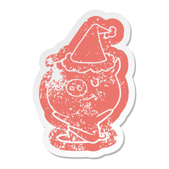 happy cartoon distressed sticker of a pig wearing santa hat
