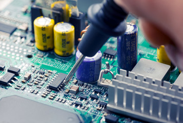 Close Up - Technician engineer measuring multimeter computer circuit board motherboard (Technology...