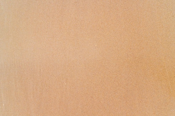 Fototapeta premium Smooth brown sand on the beach texture. Perfect for background.