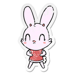 distressed sticker of a cute cartoon rabbit in dress