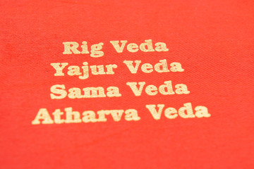 Fototapeta na wymiar Maski,Karnataka,India - March 13,2019 :The Four types of Holy Vedas printed on red textured paper