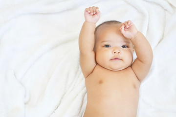 Newborn baby girl on white towel after done shower