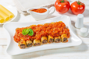 Cannelloni with ground beef baked in tomato sauce