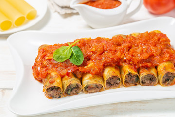 Cannelloni with ground beef baked in tomato sauce