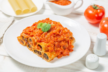 Cannelloni with ground beef baked in tomato sauce