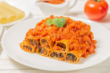 Cannelloni with ground beef baked in tomato sauce