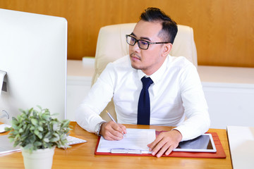 Businessman filling document