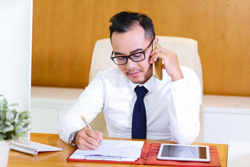 Entrepreneur writing in document