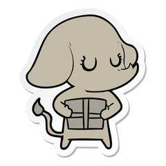 sticker of a cute cartoon elephant with gift