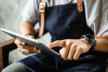 close up of man using tablet in cafe