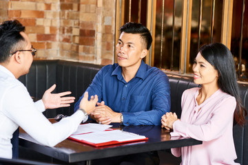 Couple meeting with estate agent