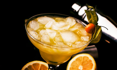 Alcoholic cocktail with beer, ice and lemon juice, bar tools. Low key, selective focus