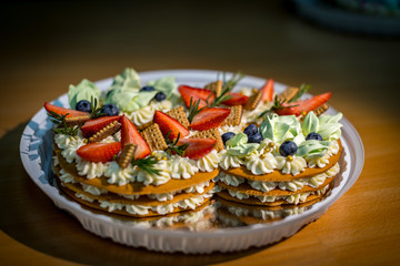 Light and fresh cake. Refined dessert made from meringue topped with low-fat whipped cream, mint leaves and strawberries