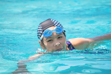 Asian women are swimming in the pool.