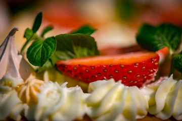 Light and fresh cake. Refined dessert made from meringue topped with low-fat whipped cream, mint leaves and strawberries
