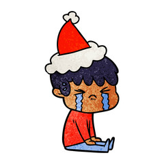 textured cartoon of a boy crying wearing santa hat
