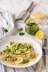 Italian spinach ravioli with pesto sauce and parmesan.