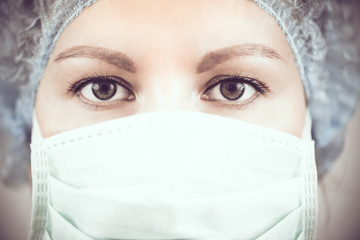 Woman face in a medical mask