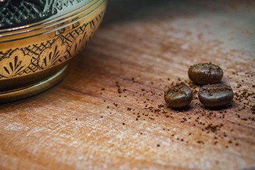 traditional coffe in turk. Coffee beans on wooden desk. Selective focus
