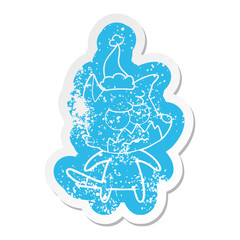 cartoon distressed sticker of a annoyed fox wearing santa hat