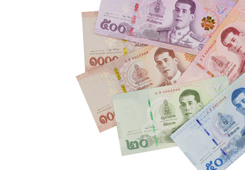 Pile of new Thai Baht banknotes, isolated on white background. Business and finance concept.
