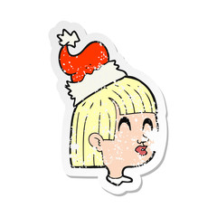 retro distressed sticker of a cartoon girl wearing santa hat