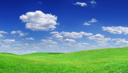 Idyllic view, green hills and blue sky with white clouds