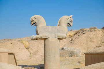 Fototapeta na wymiar Antique sculpture of Homa or Huma bird. Griffin-like column capital statuary in Persepolis. Marvdasht, Fars Province, Iran.