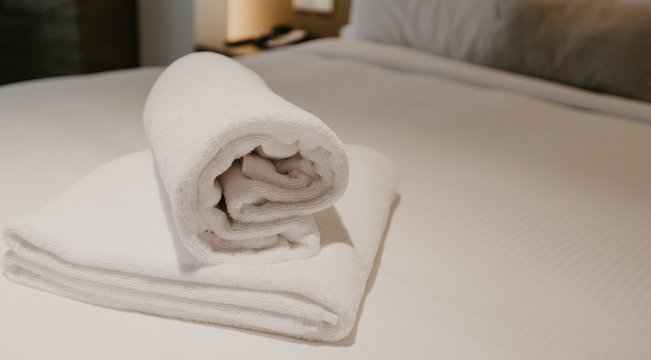 white towel decoration on bed in bed room interior